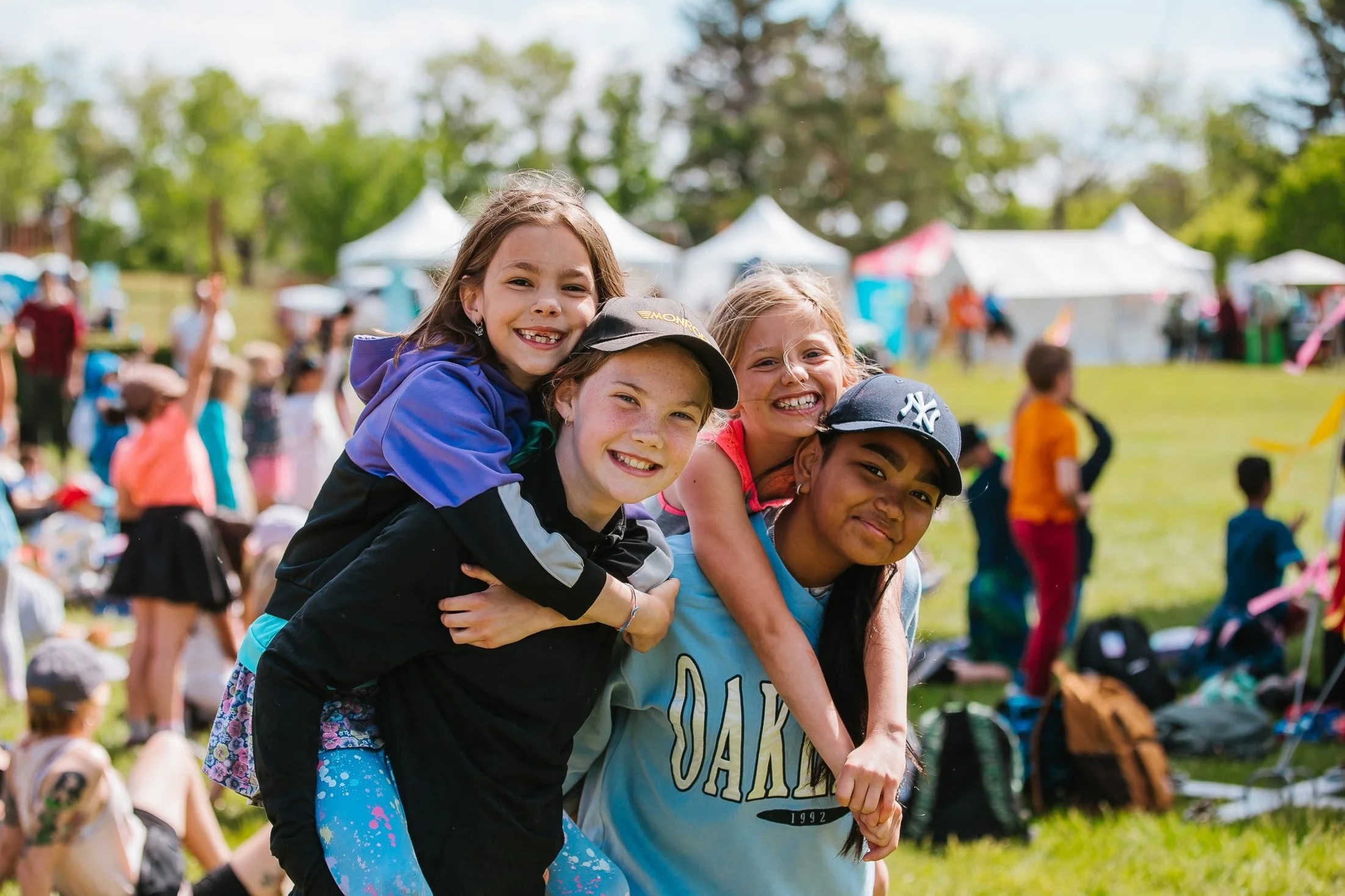 Four children smiling together at the festival
